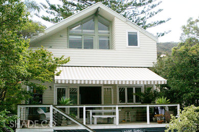 Beach style deck in Sydney with an awning.