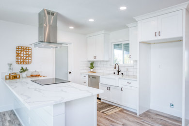 Inspiration for a mid-sized cottage galley vinyl floor and multicolored floor eat-in kitchen remodel in Other with a farmhouse sink, shaker cabinets, white cabinets, quartzite countertops, white backsplash, subway tile backsplash, stainless steel appliances, an island and white countertops