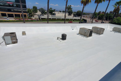 Traditional flat roof idea in Orange County with a gray roof