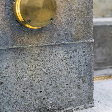 Auroralight Brass Lighting Fixture and Concrete Stairway