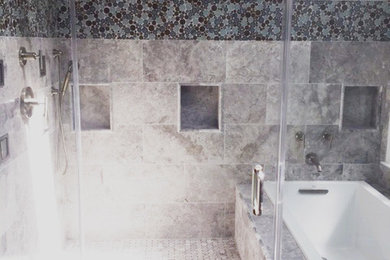 Example of a large trendy master gray tile and marble tile porcelain tile and gray floor bathroom design in Las Vegas with flat-panel cabinets, dark wood cabinets, a two-piece toilet, gray walls, an undermount sink, granite countertops and a hinged shower door