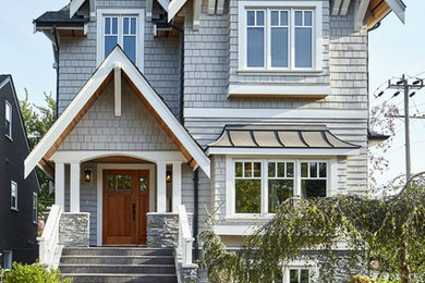 Mid-sized traditional gray three-story wood gable roof idea in Vancouver