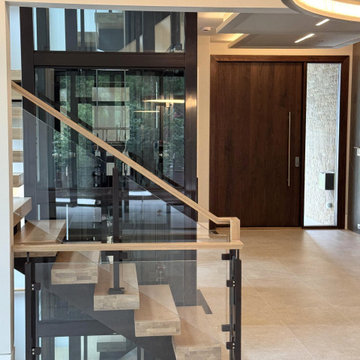 Project #136 | Modern Floating Staircase Encircling Glass Elevator