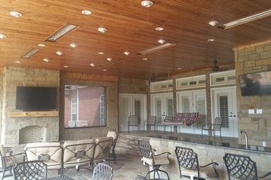 Example of a large classic backyard tile patio kitchen design in Dallas with a roof extension