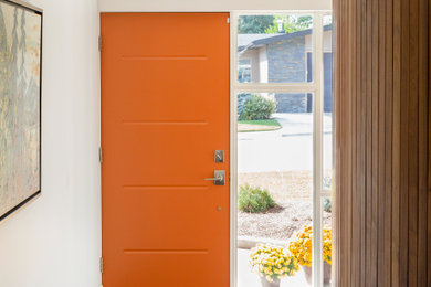 Photo of a mid-sized contemporary vestibule in Calgary with white walls, ceramic floors, a single front door, an orange front door and grey floor.