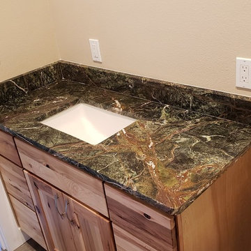 Two Green Rainforest Marble Bathrooms