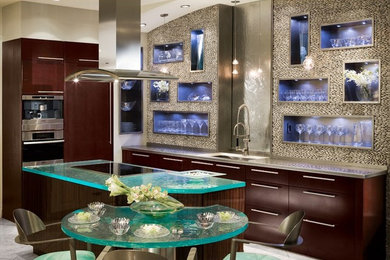 Kitchen - mid-sized contemporary l-shaped travertine floor kitchen idea in Los Angeles with a single-bowl sink, flat-panel cabinets, dark wood cabinets, stainless steel countertops, gray backsplash, stainless steel appliances and an island