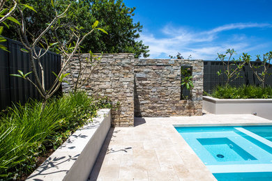 Inspiration for a large contemporary backyard rectangular aboveground pool in Perth with a water feature and natural stone pavers.