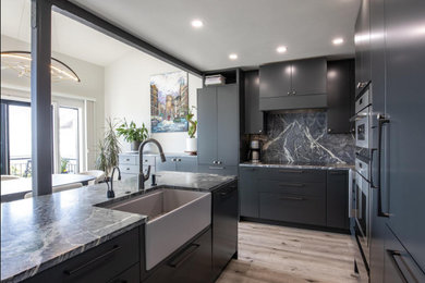 Eat-in kitchen - small contemporary l-shaped vinyl floor, brown floor and vaulted ceiling eat-in kitchen idea in San Francisco with a farmhouse sink, flat-panel cabinets, black cabinets, soapstone countertops, multicolored backsplash, black appliances, an island and multicolored countertops