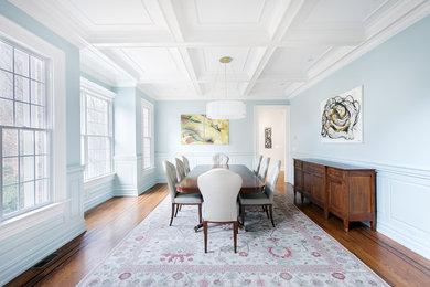 Example of a large trendy medium tone wood floor and brown floor kitchen/dining room combo design in Philadelphia with blue walls and no fireplace