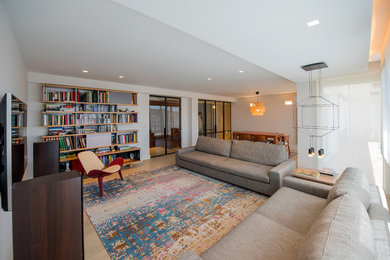 Inspiration for a mid-sized contemporary enclosed living room library remodel in Madrid with white walls and a wall-mounted tv