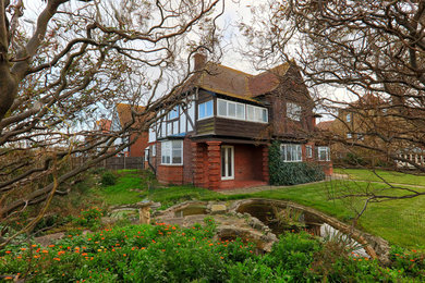 This is an example of a beach style home design in Sussex.
