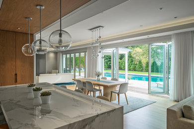 Large contemporary kitchen/dining combo in Boston with white walls and light hardwood floors.
