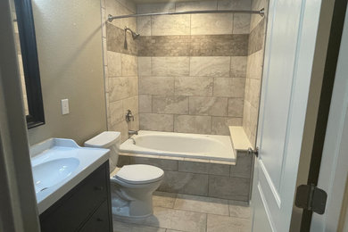 Mid-sized elegant kids' brown tile and porcelain tile porcelain tile and beige floor bathroom photo in Denver with beige walls and a freestanding vanity