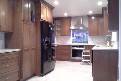 Inspiration for a mid-sized craftsman u-shaped linoleum floor enclosed kitchen remodel in San Francisco with an undermount sink, shaker cabinets, dark wood cabinets, granite countertops, beige backsplash, ceramic backsplash, black appliances and no island