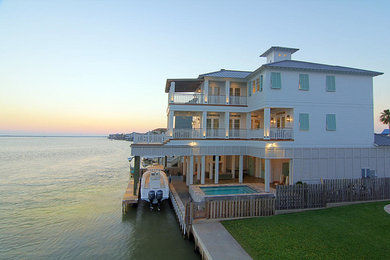 Inspiration for a large timeless white three-story exterior home remodel in Houston