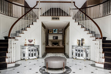 Foyer - large traditional marble floor foyer idea in New York with white walls
