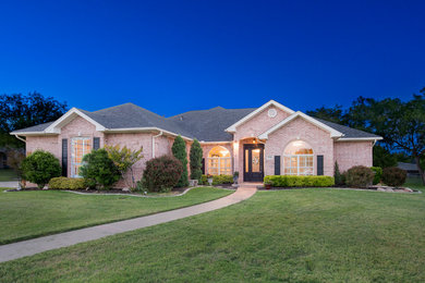 Inspiration for a large timeless one-story brick exterior home remodel in Austin