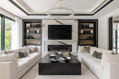 Inspiration for a large transitional open concept light wood floor and tray ceiling living room remodel in Toronto with white walls, a ribbon fireplace, a stone fireplace and a wall-mounted tv