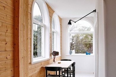 This is an example of a scandinavian hallway in Sydney with white floor.