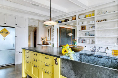 Open concept kitchen - large country u-shaped medium tone wood floor and brown floor open concept kitchen idea in Atlanta with a farmhouse sink, recessed-panel cabinets, yellow cabinets, granite countertops, stainless steel appliances and an island