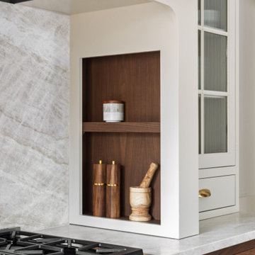 Elegant Two-Tone Kitchen with Walnut Cabinetry and Statement Stone Backsplash
