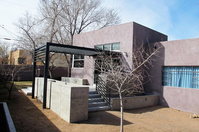 Inspiration for a mid-sized modern one-storey stucco exterior in Albuquerque with a flat roof.