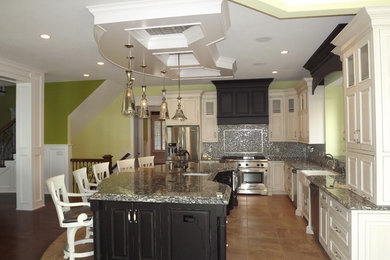 Example of a large classic u-shaped porcelain tile open concept kitchen design in Other with a farmhouse sink, raised-panel cabinets, white cabinets, granite countertops, metallic backsplash, mosaic tile backsplash, stainless steel appliances and an island