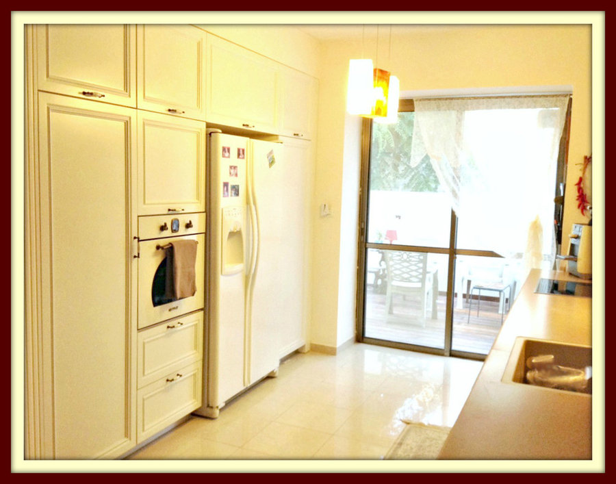 delicious creamy kitchen with doors to the deck