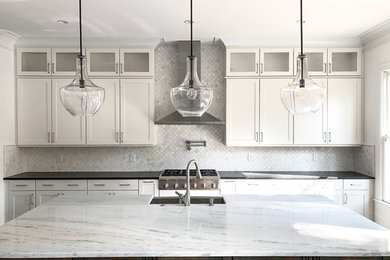 Open concept kitchen - large craftsman l-shaped open concept kitchen idea in Atlanta with a farmhouse sink, shaker cabinets, white cabinets, quartzite countertops, white backsplash, marble backsplash, stainless steel appliances, an island and white countertops