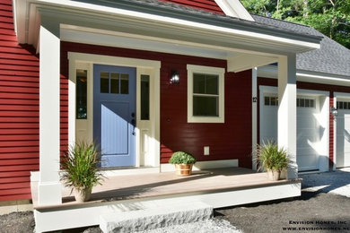 На фото: двухэтажный, деревянный, красный частный загородный дом среднего размера в стиле кантри с двускатной крышей и крышей из гибкой черепицы с