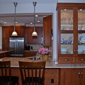 Warm Wood Kitchen Remodel | Angled Granite Island & Integrated Display Cabinets
