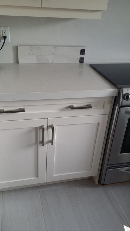 marble look alike countertops with real marble backsplash?