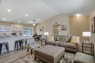 Living room - mid-sized transitional open concept laminate floor and beige floor living room idea in Phoenix with beige walls, no fireplace and a tv stand