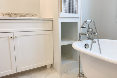 Bathroom - mid-sized transitional master porcelain tile, multicolored floor, double-sink, vaulted ceiling and wallpaper bathroom idea in Indianapolis with shaker cabinets, white cabinets, a one-piece toilet, blue walls, an undermount sink, marble countertops, a hinged shower door and a built-in vanity