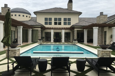 Pool house - large mediterranean backyard concrete paver and rectangular natural pool house idea in Other