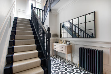 Design ideas for a medium sized victorian painted wood u-shaped wood railing staircase in Berkshire with carpeted risers and panelled walls.