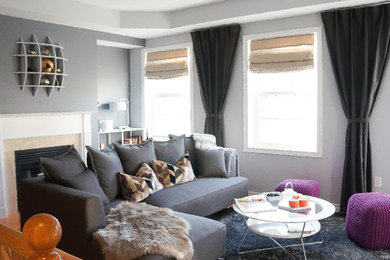 Large trendy open concept medium tone wood floor living room photo in Toronto with gray walls, a standard fireplace, a stone fireplace and a wall-mounted tv