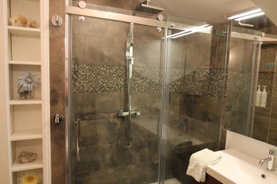 Inspiration for a small contemporary 3/4 gray tile and porcelain tile porcelain tile, gray floor, single-sink and vaulted ceiling bathroom remodel in Other with dark wood cabinets, a wall-mount toilet, white walls, an integrated sink, white countertops and a floating vanity