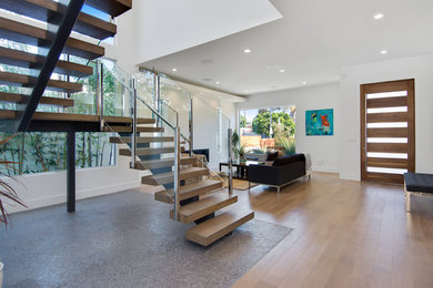 Living room - large 1950s open concept light wood floor living room idea in Los Angeles with white walls, a ribbon fireplace and a tile fireplace