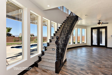 Large tuscan wooden floating staircase photo in Salt Lake City with wooden risers