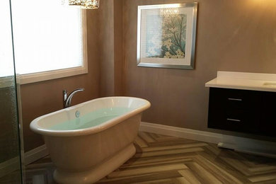 Bathroom - mid-sized contemporary master white tile ceramic tile and beige floor bathroom idea in Toronto with flat-panel cabinets, dark wood cabinets, beige walls, an undermount sink and solid surface countertops
