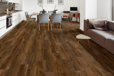 Example of a mid-sized transitional open concept medium tone wood floor and brown floor family room design in Tampa with white walls and no tv