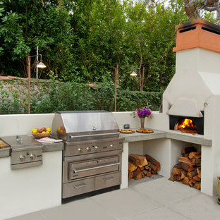 Photo of a mediterranean backyard patio in Los Angeles with concrete pavers and no cover.