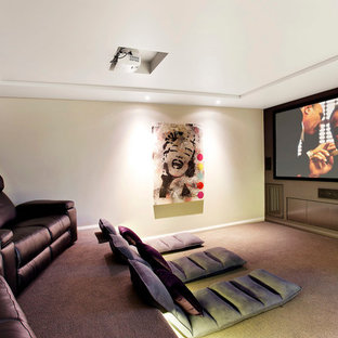 Example of a small trendy enclosed carpeted home theater design in Sydney with gray walls and a projector screen