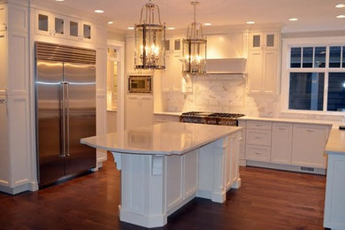 Inspiration for a huge transitional l-shaped medium tone wood floor enclosed kitchen remodel in Vancouver with stainless steel appliances, an island, a double-bowl sink, shaker cabinets, white cabinets, quartzite countertops, multicolored backsplash and stone tile backsplash