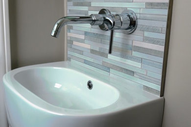 Small trendy multicolored tile and porcelain tile porcelain tile powder room photo in San Francisco with a wall-mount toilet, beige walls and a wall-mount sink