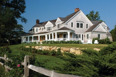 This is an example of a mid-sized traditional two-storey grey exterior in Boston with wood siding.
