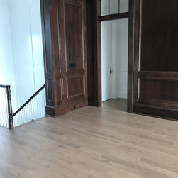 Sophisticated Built-ins & Neutral Floors - Hardwood Flooring