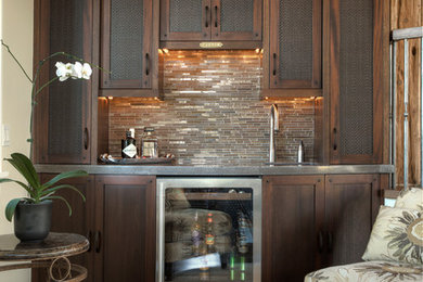 Example of a mid-sized arts and crafts single-wall dark wood floor wet bar design in Detroit with an undermount sink, shaker cabinets, dark wood cabinets, stainless steel countertops and beige backsplash